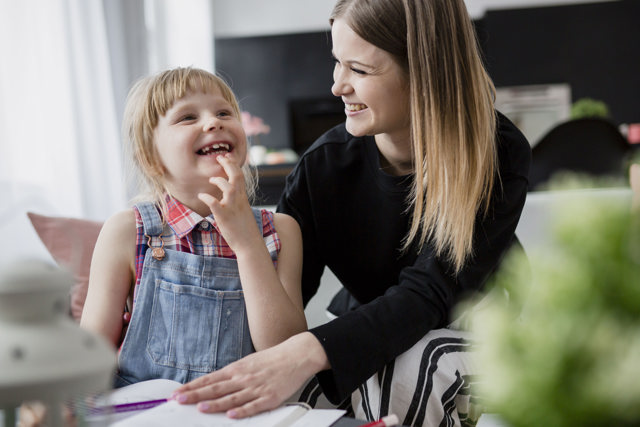 Laughing Mother Daughter Doing Homework Image By Magnific