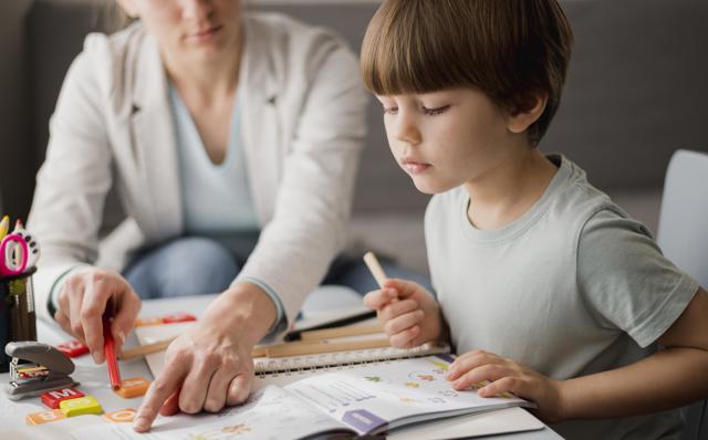 Side View Child Learning From Tutor Home