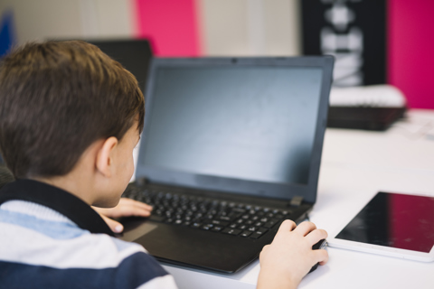 Rear View Little Boy Using Laptop Mouse