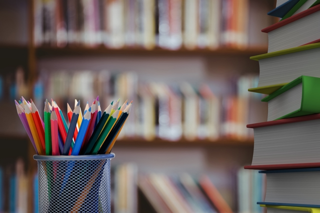 Close Up Colored Pencils With Books